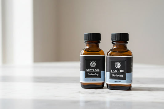 Two bottles of shave oil from a barbershop on a white background