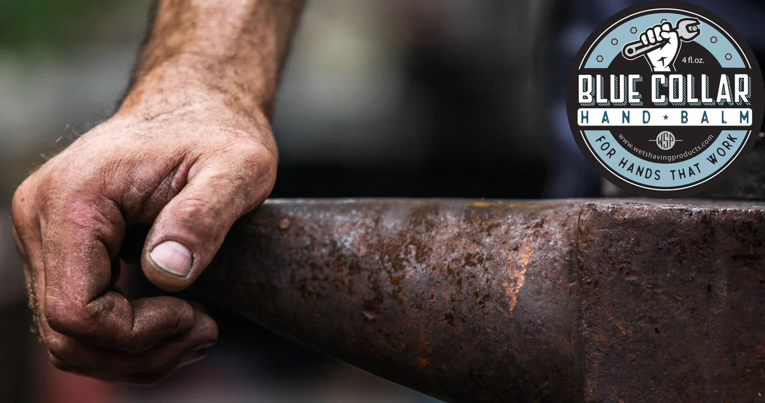 Work-worn man's hand resting on an anvil with Blue Collar Hand Balm