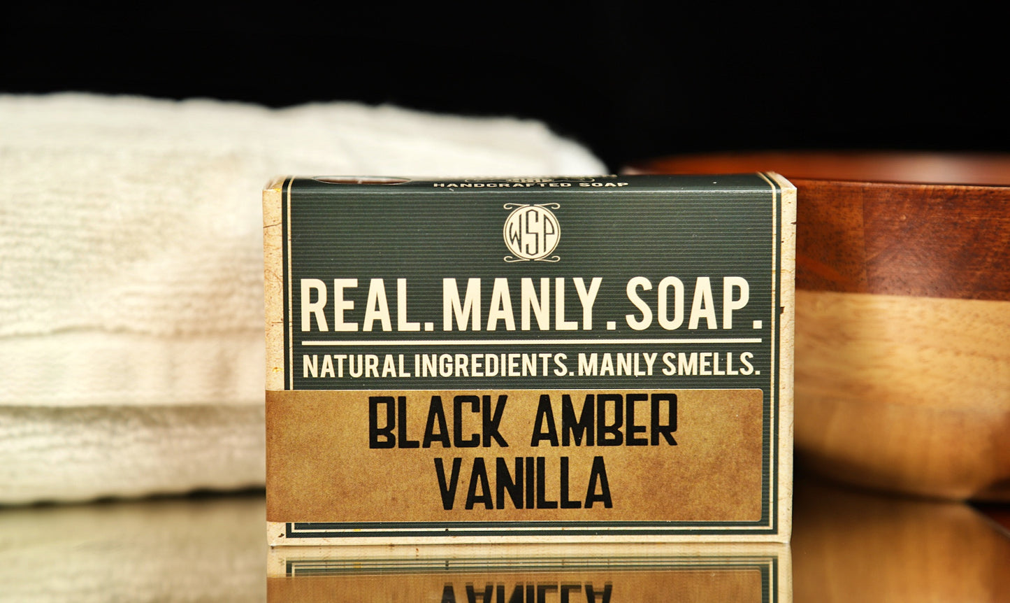 WSP Bar Soap Black Amber Vanilla scent with a towel and bowl in the background.