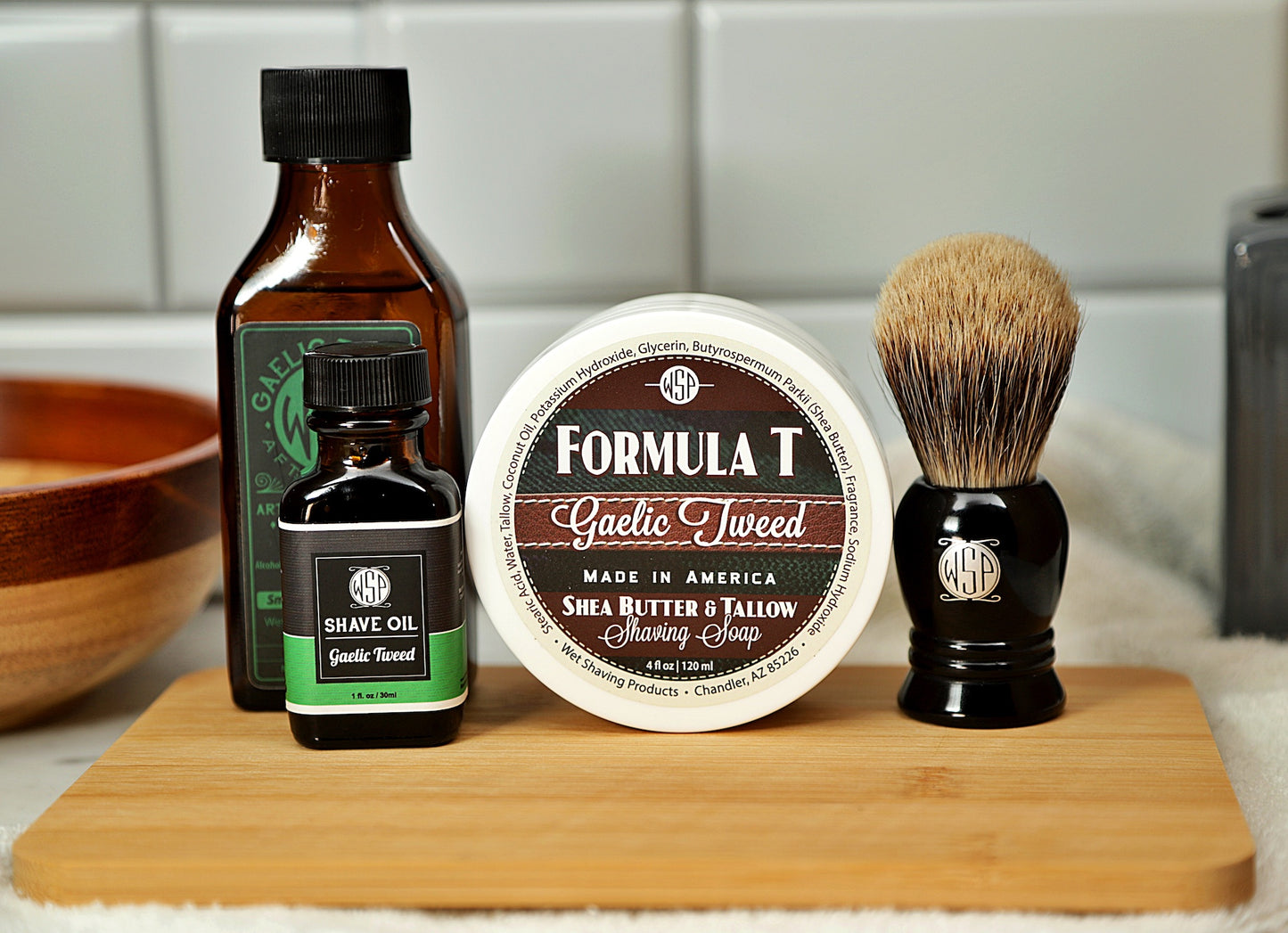 WSP Shaving Set of Gaelic Tweed shave oil, rustic shaving soap, aftershave tonic and shaving brush all sitting on wooden board with white towel