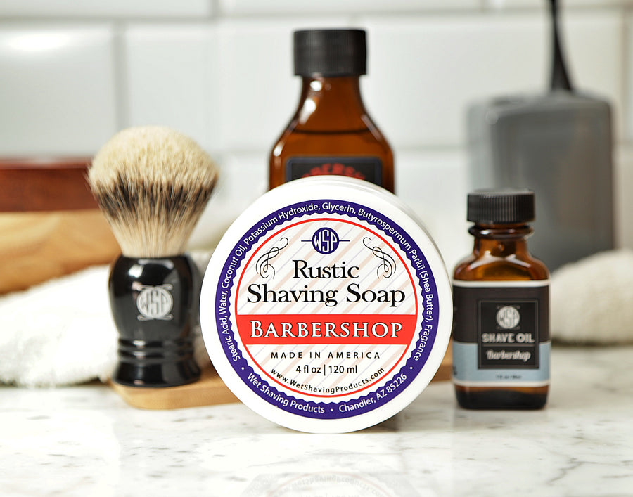 Shaving Set of Barbershop shave oil, Rustic shaving soap, aftershave tonic and shaving brush all sitting on wooden board with white towel
