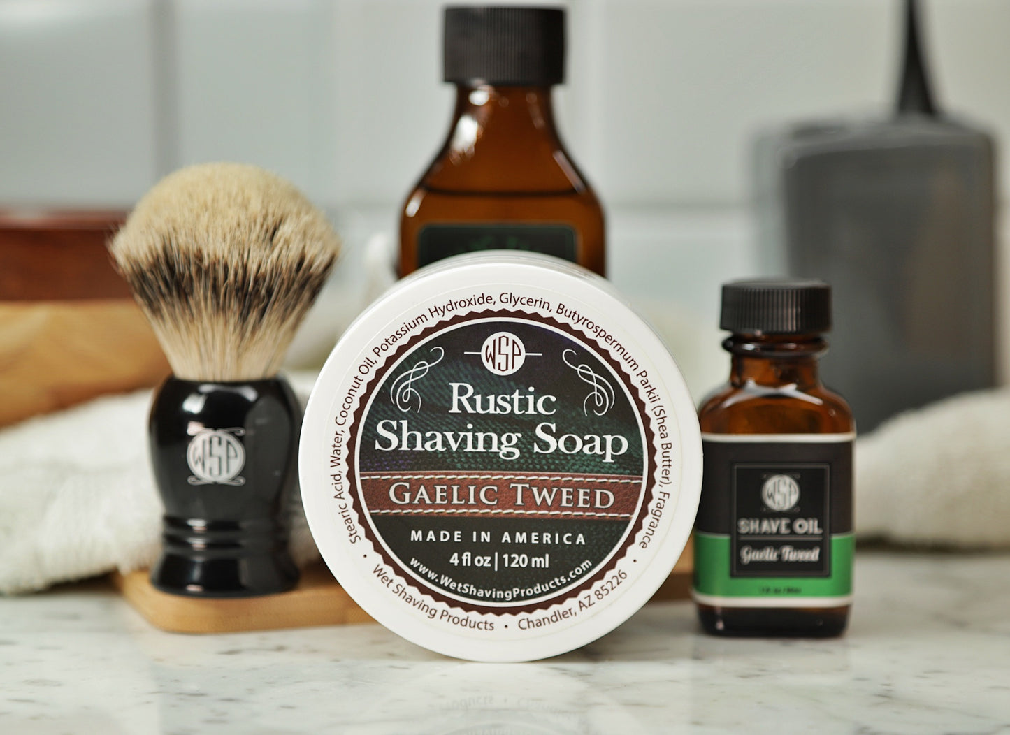 Shaving Set of Gaelic Tweed shave oil, rustic shaving soap, aftershave tonic and shaving brush all sitting on wooden board with white towel