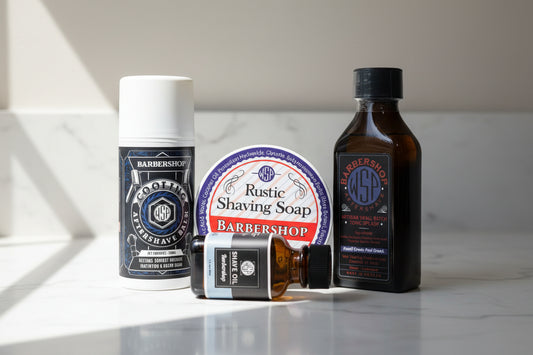 Collection of barbershop products including aftershave, soap, and oil on a white background