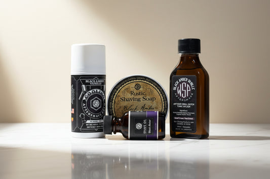 Collection of Black Amber Vanilla grooming products including aftershave, soap, and oil on a white background.