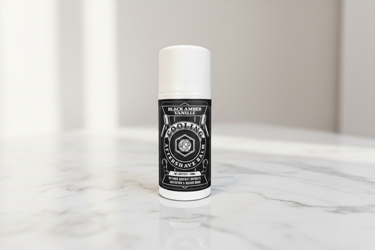 wsp black amber aftershave balm Sitting on a clean, polished white Carrara marble surface with faint grey veining, bright clean morning light from the left, out of focus pale neutral background, premium spa atmosphere, sharp focus on the product.