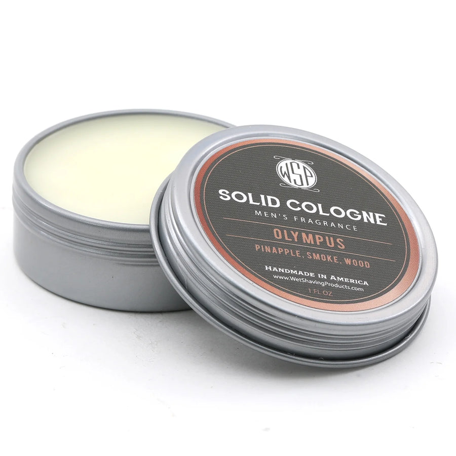 Open tin of WSP's Olympus Solid Cologne with the lid leaning against the balm.