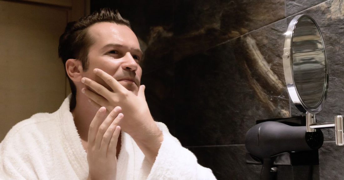 Man splashing aftershave on face after shaving.