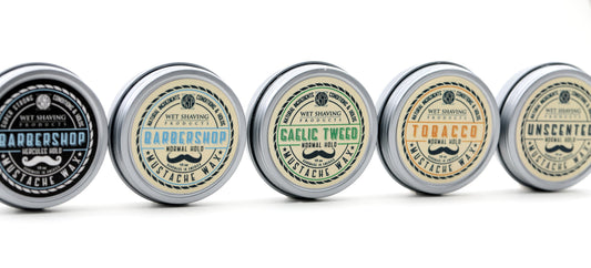 Assorted mustache wax tins on display.