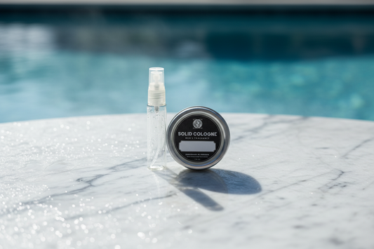 Solid cologne spray bottle and container on a marble surface with a pool in the background