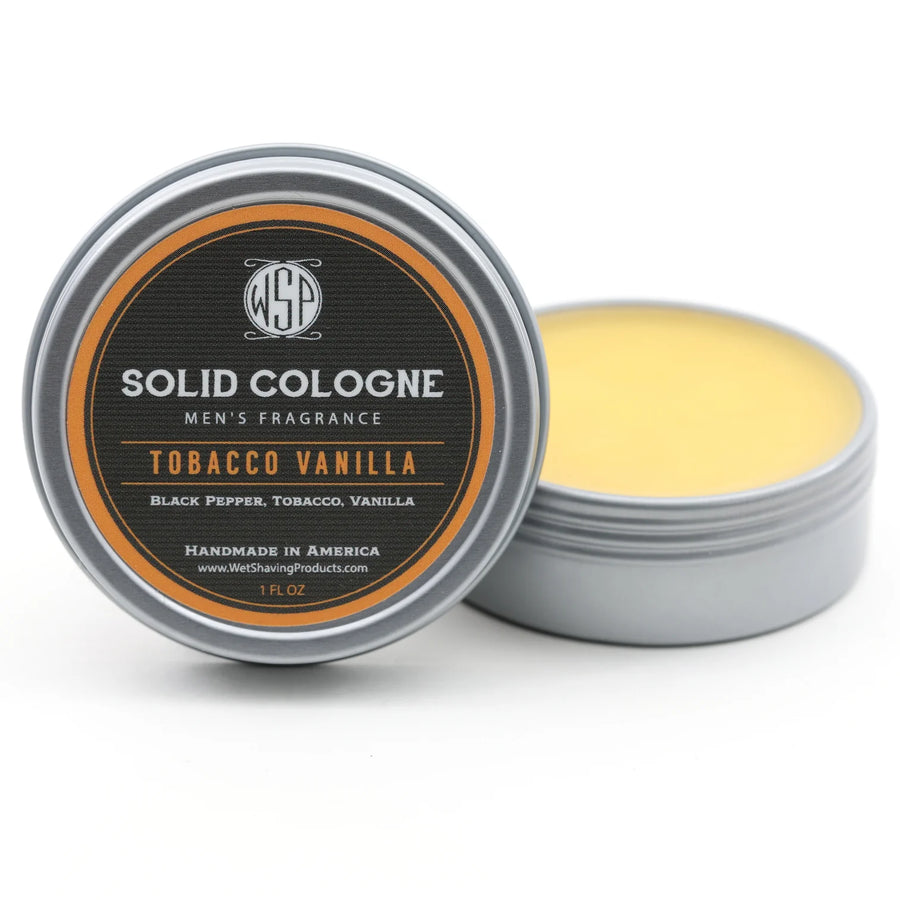 Open tin of WSP Tobacco Vanilla Signature Solid Cologne, with the lid leaning against the fragrant solid content.