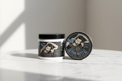 Hair paste container with branding and product details on a white background