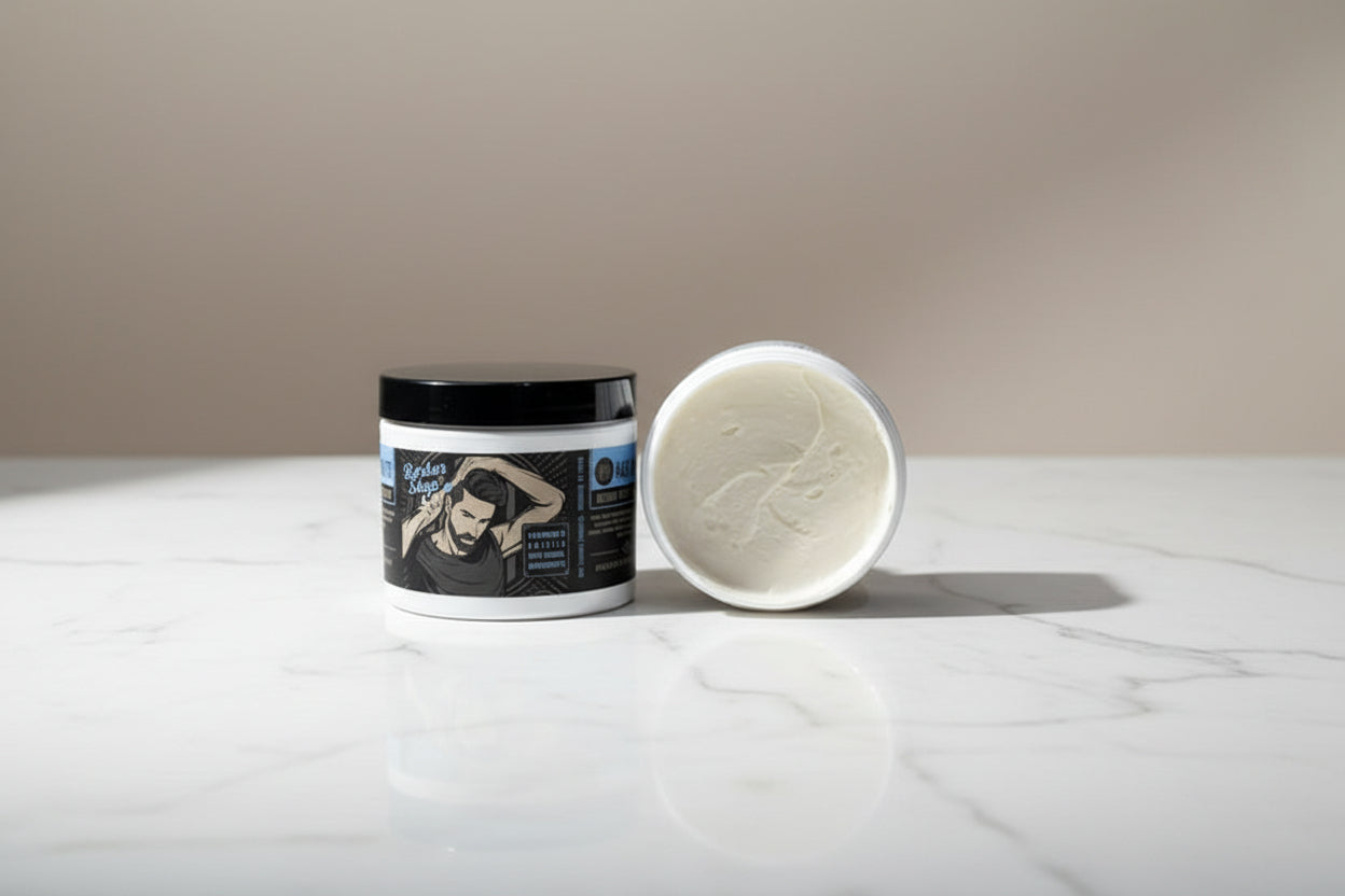 Barber shop product container with open lid showing white cream inside on a white background