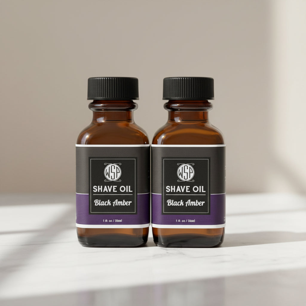 Two bottles of WSP Shave Oil Black Amber on a white background