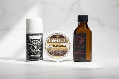 Three cosmetic products including a bottle, a jar, and a tube on a textured surface.