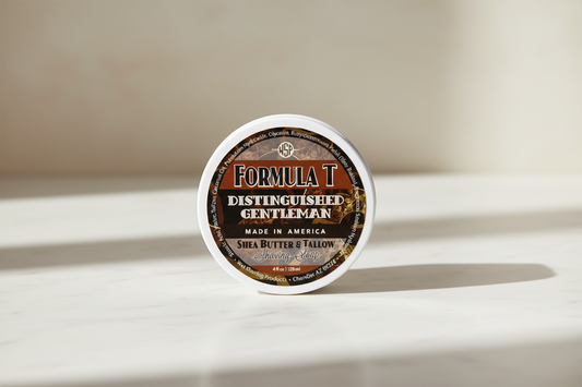 Container of Formula T Distinguished Gentleman hair product on a white surface with a neutral background