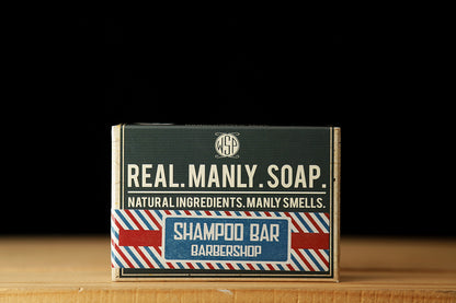 WSP Shampoo Bar in Barbershop scent sitting on a wooden table