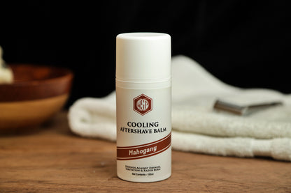 Small white bottle on table WSP Cooling Aftershave Balm in Mahogany scent