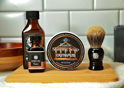 WSP Shaving Set of Olympus shave oil, rustic shaving soap, aftershave tonic and shaving brush all sitting on wooden board with white towel