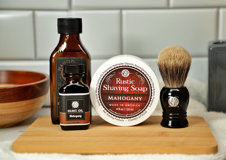 WSP Shaving Set of Mahogany shave oil, rustic shaving soap, aftershave tonic and shaving brush all sitting on wooden board with white towel