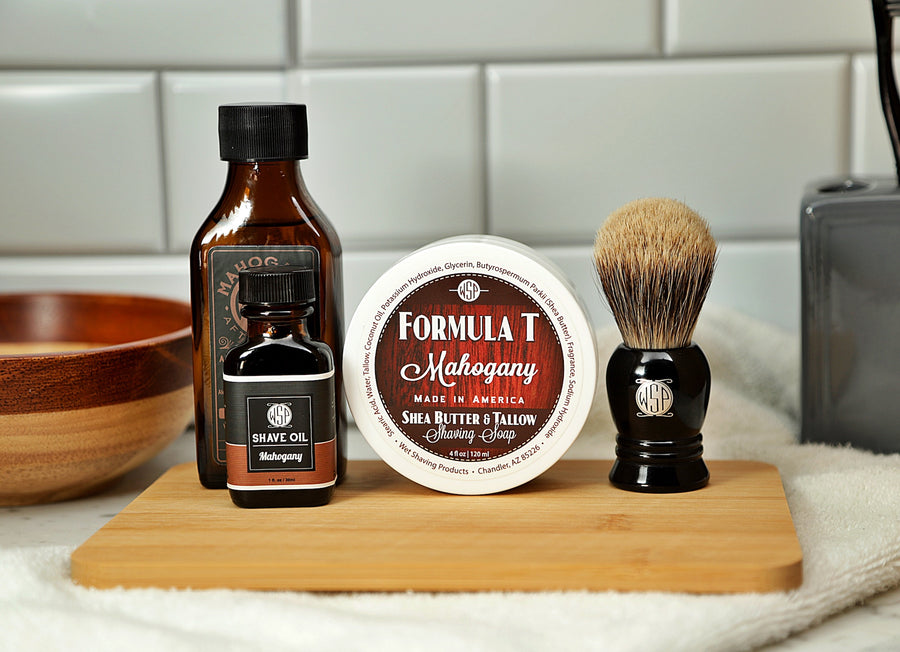 WSP Shaving Set of Mahogany shave oil, rustic shaving soap, aftershave tonic and shaving brush all sitting on wooden board with white towel