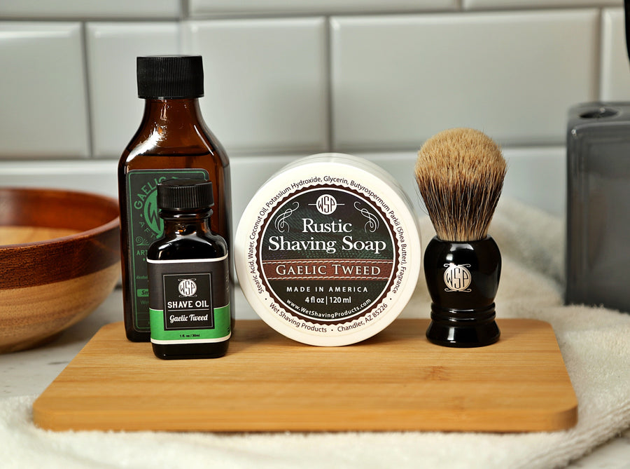 WSP Shaving Set of Gaelic Tweed shave oil, rustic shaving soap, aftershave tonic and shaving brush all sitting on wooden board with white towel