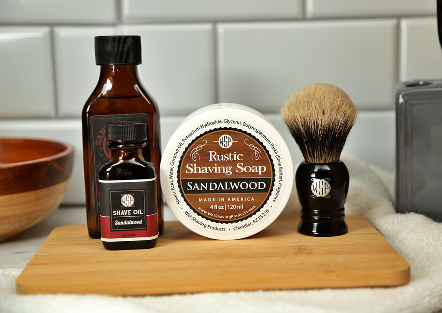 WSP SHAving Set of Sandalwood shave oil, rustic shaving soap, aftershave tonic and shaving brush all sitting on wooden board with white towel