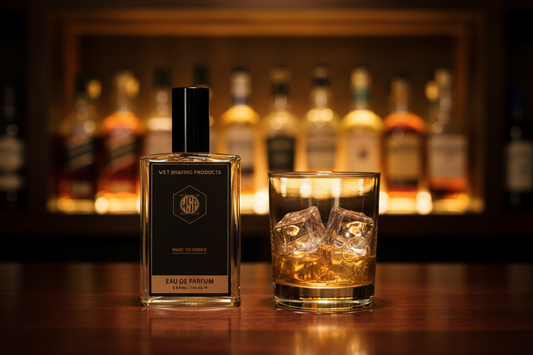 Cologne bottle centered on a polished dark mahogany bar surface next to a crystal rocks glass with ice, warm golden backlighting glowing through the liquid, out of focus background of amber whiskey bottles stacked on shelves, rich warm tones, cinematic lighting, photorealistic, 8k resolution.