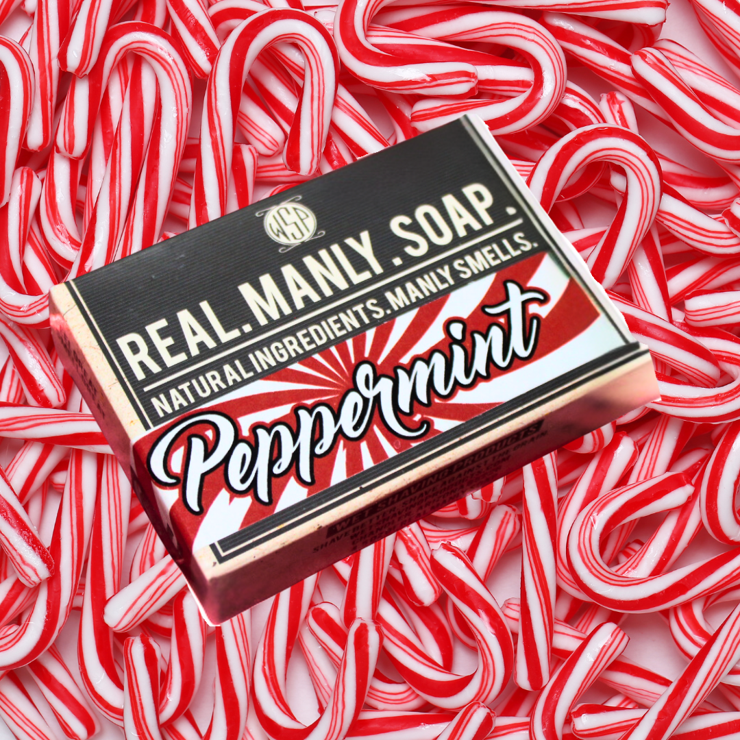 Real Manly Soap in Peppermint scent laying on top of a pile of red and white candy canes.