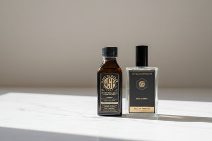 Two bottles of WSP products on a marble countertop with a blurred cream background.