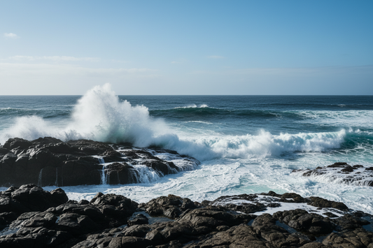 Rugged ocean coastline with crashing blue waves and sea spray, symbolizing refreshing aquatic and citrus colognes for men.