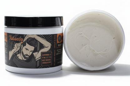 Jar of tobacco-scented grooming product with open lid showing cream inside on a white background