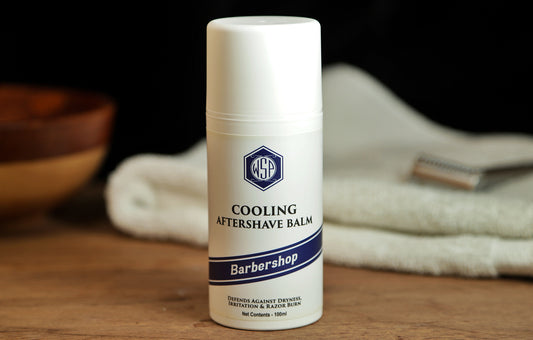 Small white bottle on table WSP Cooling Aftershave Balm in Barbershop scent