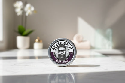 black amber Beard balm container with branding on a textured surface