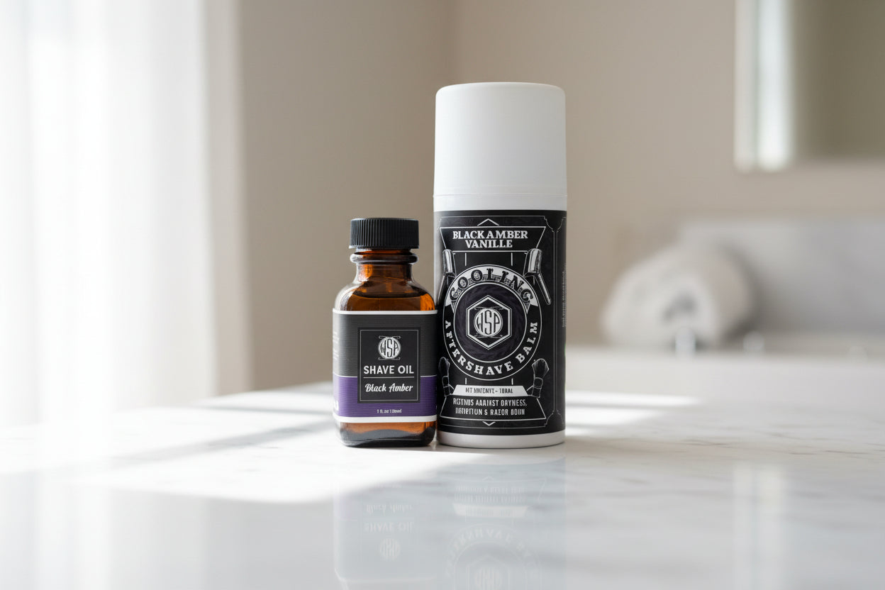 Two bottles of shaving products on a marble surface with a blurred background