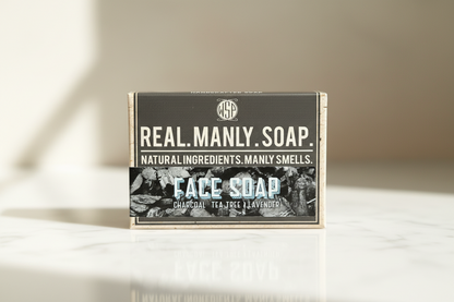 Box of Real Manly Face Soap on a light surface with a neutral background