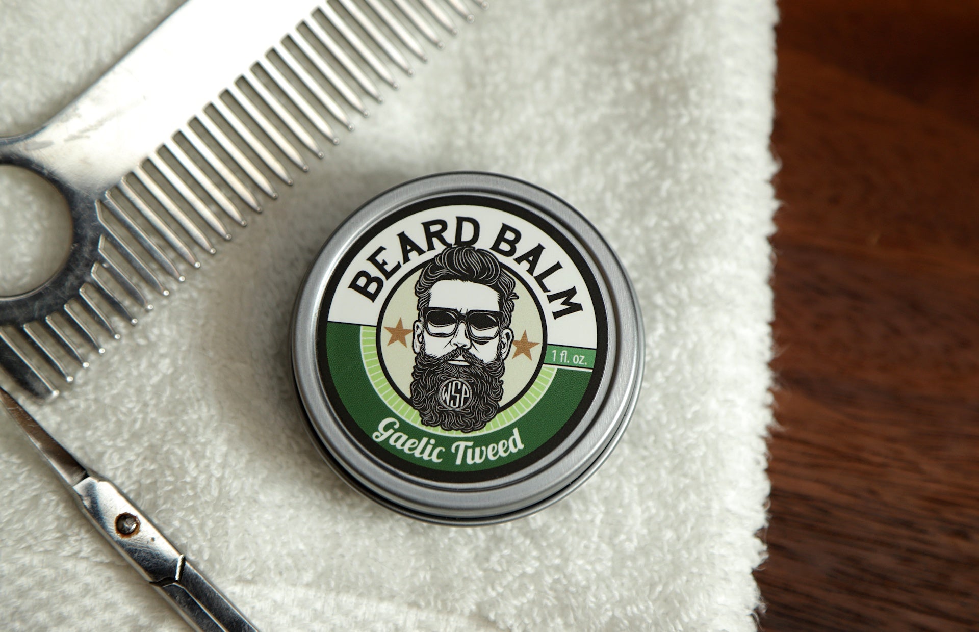 WSP Beard Balm Gaelic Tweed on towel with scissors and comb