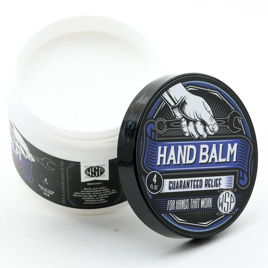 Open tub of Blue Collar Hand Balm with lid leaning against it