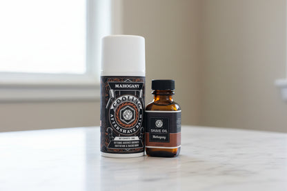 Two bottles of shaving products on a marble surface with a neutral background