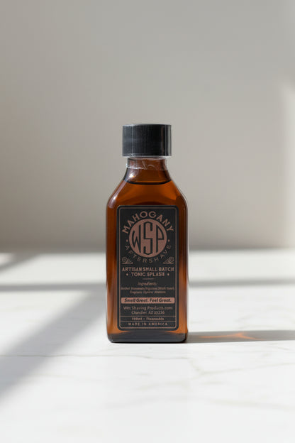 Bottle of Mahogany Aftershave with a black label on a white background