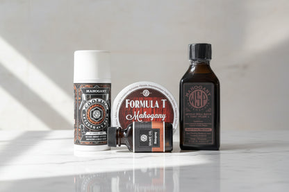 Collection of Mahogany grooming products including an aftershave, oil, and other items on a surface.