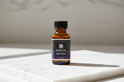 Bottle of shave oil labeled 'Black Amber' on a white background