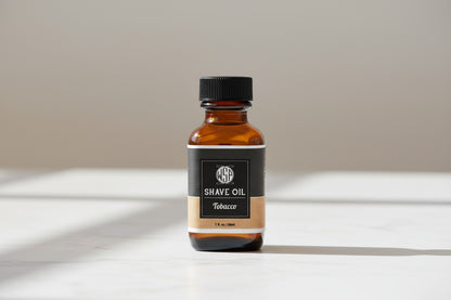 Bottle of shave oil with a black label on a white background