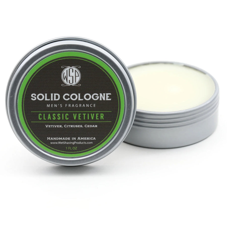 Open tin of WSP Classic Vetiver Signature Solid Cologne, with the lid leaning against the fragrant solid cologne.