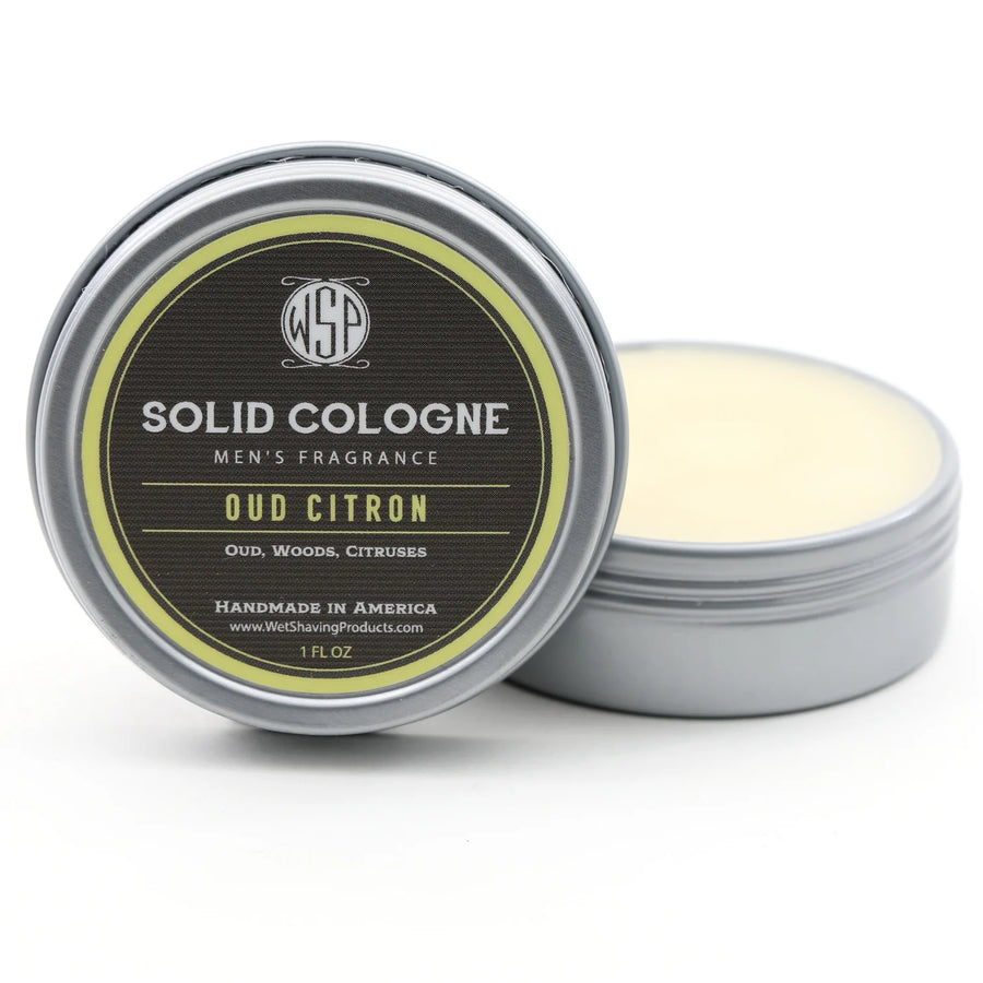 Open tin of WSP Oud Citron Signature Solid Cologne, with the lid leaning against the fragrant solid cologne.
