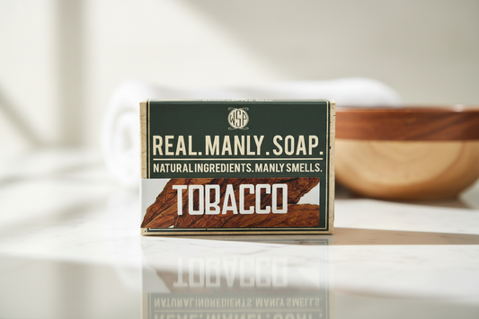 Box of Real. Manly. Soap Tobacco on a reflective surface with a blurred background
