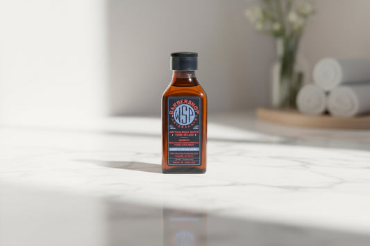 Bottle of WSP Barbershop Aftershave on a white countertop
