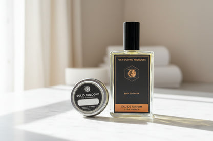 Bottle of eau de parfum and solid cologne on a wooden surface with a blurred background