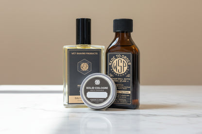 Three bottles of grooming products on a wooden surface with a blurred background
