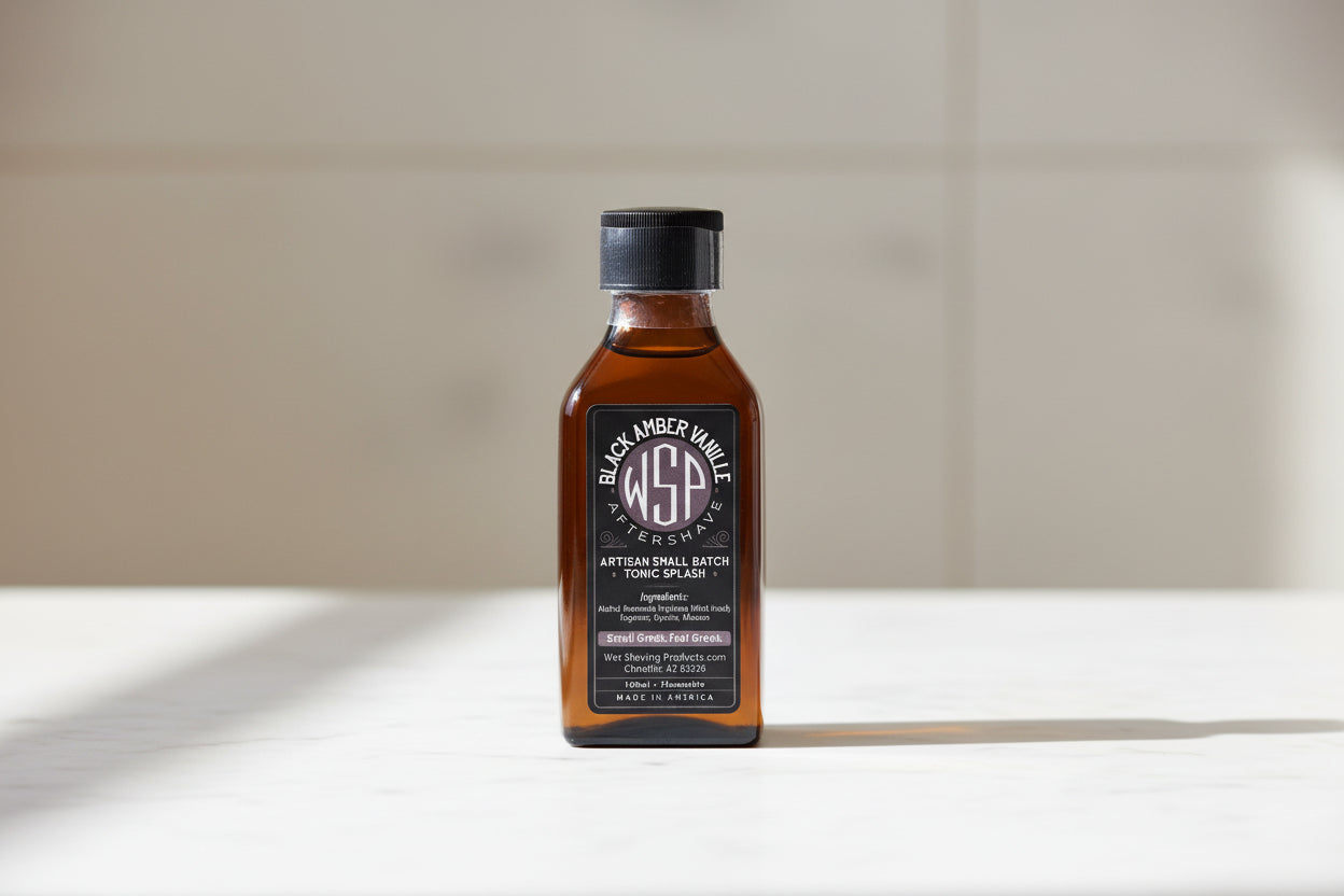 Bottle of Black Amber aftershave splash on a white surface with a neutral background